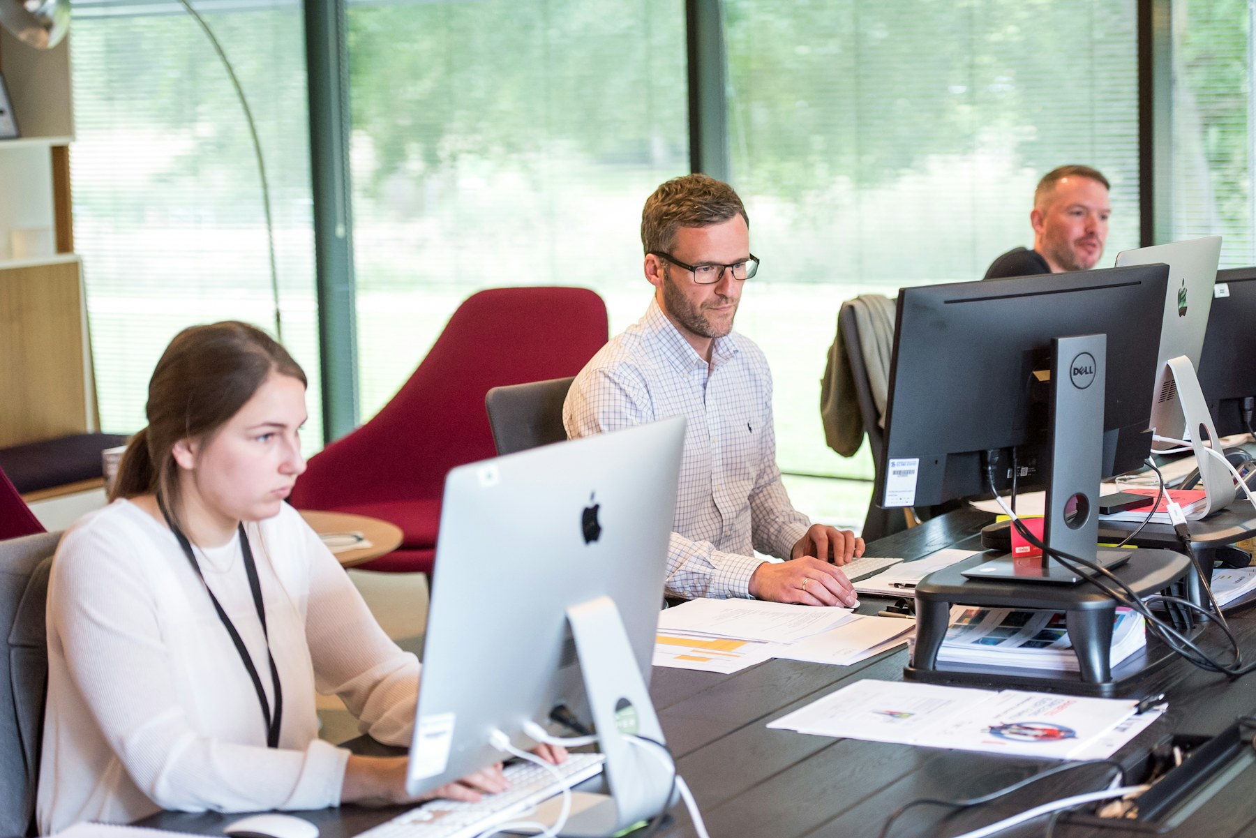 Operations team working across connected computer systems